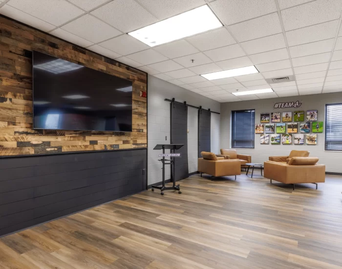 meeting room with TV on a reclaimed wood wall
