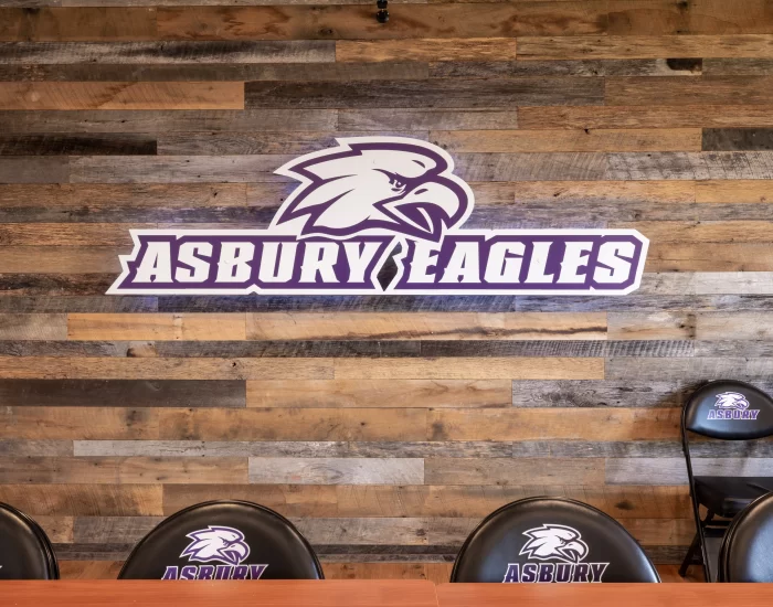 Asbury Logo on a wooden accent wall