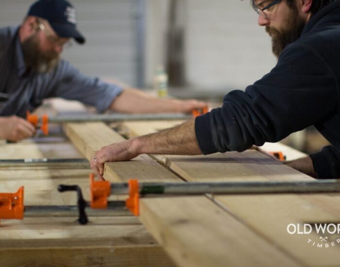 Two workers cuting wood