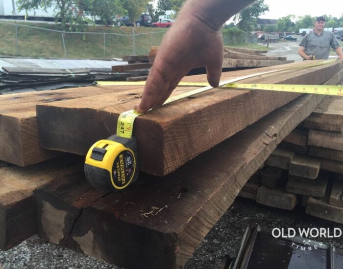 Measuring timbers with two steel retractable tapes