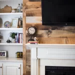A living room with a fireplace and bookshelves