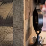 A mirror is sitting on a wooden wall