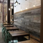 The interior of a restaurant with wooden tables and chairs