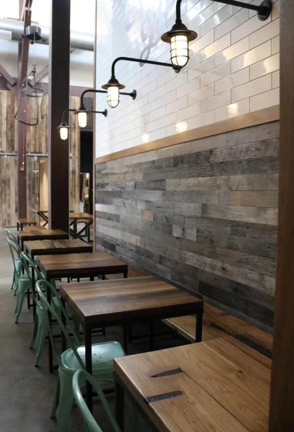 The interior of a restaurant with wooden tables and chairs