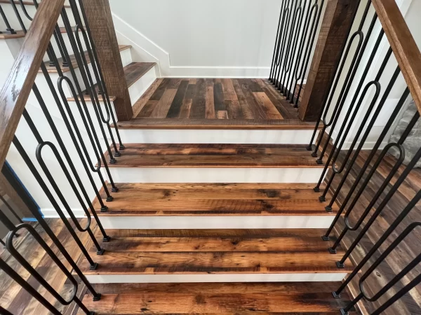 A staircase with wood treads and metal railings.