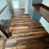 A staircase with wood floors and a railing.