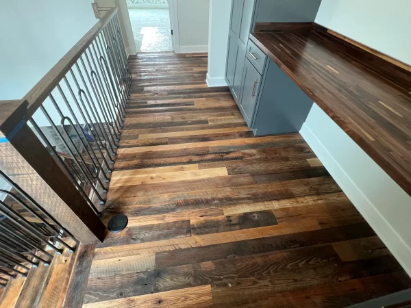 A staircase with wood floors and a railing.