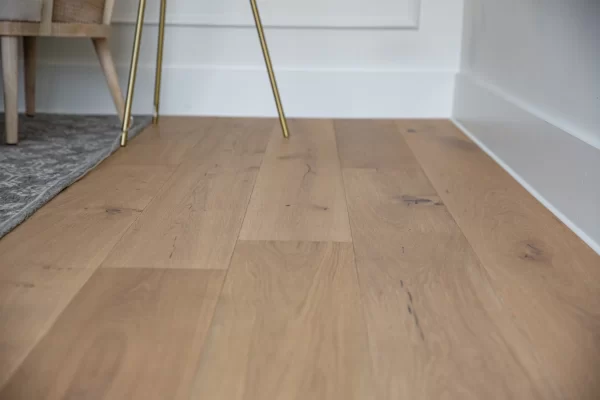 A wooden floor in a room with white walls