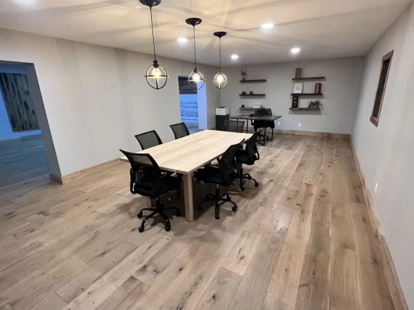 A conference room with a wooden table and chairs.