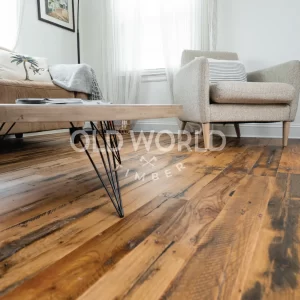 Engineered oak flooring reclaimed from antique factories installed in a cozy, modern living room with neutral-toned furniture and natural lighting.