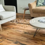 Industrial Oak engineered wood flooring in a modern living room with neutral decor and reclaimed textures visible on each plank.