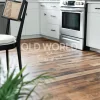 Close-up of Industrial Oak Engineered Flooring reclaimed from antique factories, installed in a white kitchen with stainless steel appliances.