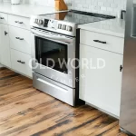 Reclaimed Industrial Oak flooring showcasing dark grain patterns and historic nail holes in a contemporary kitchen setting.