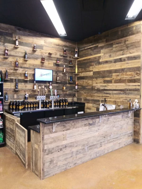 A bar with a wooden wall behind it
