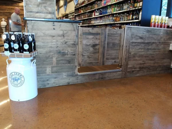 A store with a wooden counter and a bottle of beer.