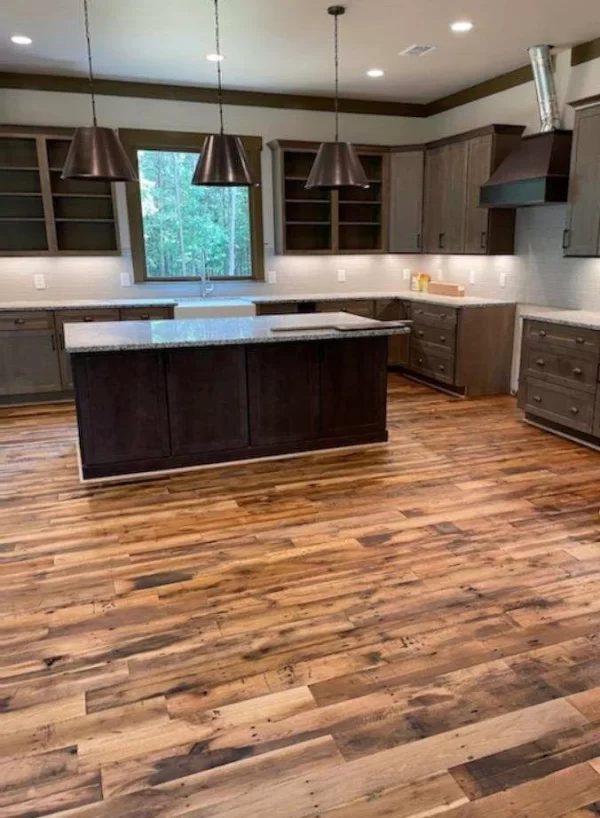 A kitchen with wood floors and a center island.