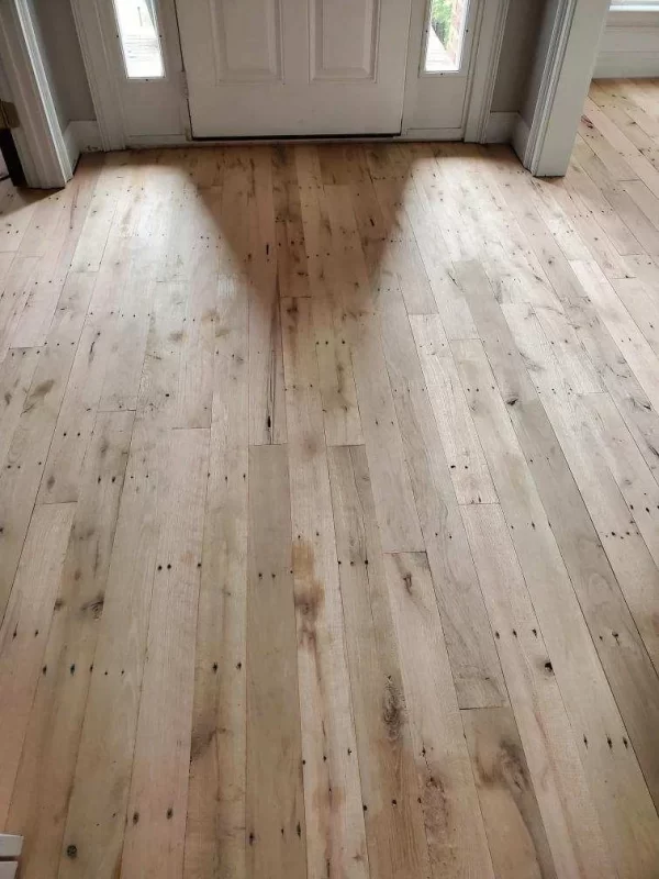 A room with a wooden floor and a door.