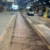 A piece of wood is being cut in a factory