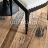 Close-up of Old World Timber’s Heartland Barnwood Mixed Oak engineered reclaimed flooring beneath a dining chair, showing knots and weathered grain.