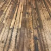Expansive floor view of Old World Timber’s reclaimed Heartland Barnwood Mixed Oak engineered flooring featuring a variety of tones, saw marks, and rustic patina in a continuous plank layout.