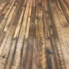 Expansive floor view of Old World Timber’s reclaimed Heartland Barnwood Mixed Oak engineered flooring featuring a variety of tones, saw marks, and rustic patina in a continuous plank layout.