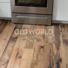 Old World Timber’s engineered Heartland Barnwood flooring beneath a stainless Frigidaire oven, showcasing reclaimed rustic charm.