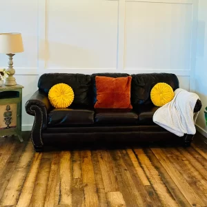 mixed hardwood reclaimed engineered flooring with a sofa and pillows