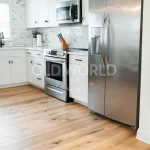 Frontal view of stainless steel appliances and subway tile backsplash atop Modern Harvest engineered flooring with warm oak tones and clean lines.
