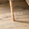 Industrial oak clean face engineered wood flooring with soft character marks under a rounded wooden table leg in a modern home.