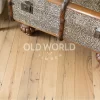 Close-up of vintage leopard-print chest sitting on light reclaimed oak flooring, showing wormholes and saw marks from its former life in factories.