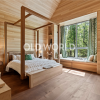 Oak Rift and Quartered engineered wood flooring in a modern bedroom with natural wood walls and large picture window.