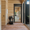 Contemporary home entry with Oak Rift and Quartered flooring and vertical wood paneling.