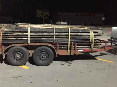 Reclaimed and recycled barnwood planks placed on a transport truck