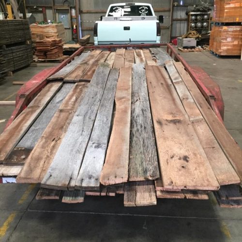 Reclaimed lumber planks that are placed on a transport truck