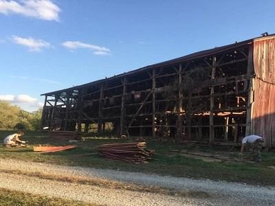 an old antique red barn being recycled, reclaimed and repurposed into interior design products to last for many more years