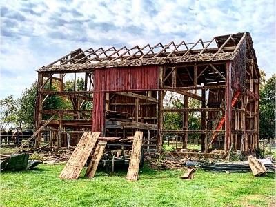 An old antique wood red barn being recycled, reclaimed and repurposed into interior design products to last for many more years