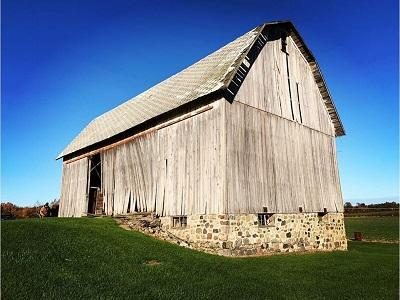 An old antique gray barn ready to be recycled, reclaimed and repurposed into interior design products to last for many more years